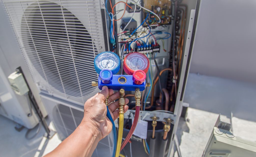 Air conditioning, HVAC service technician using gauges to check