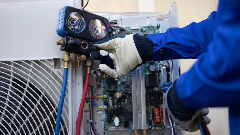 Close up Air conditioner's technician hand check fill refrigerant liquid and maintenance condensor unit, Home care service