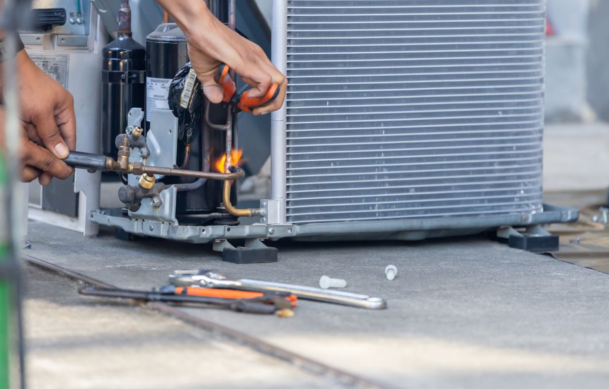 Close up of Air Conditioning Repair team use fuel gases and oxygen to weld or cut metals