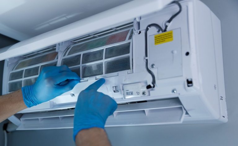 Professional-Technician-Performing-Maintenance-on-a-Split-Air-Conditioning-Unit-with-Focus-on-Filter-Replacement