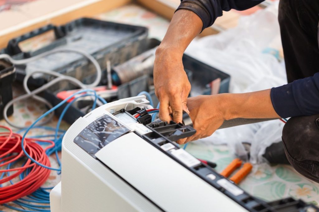Repairman fix air conditioning systems