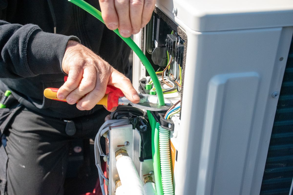 Technician Working on an Air Source Heat Pump System